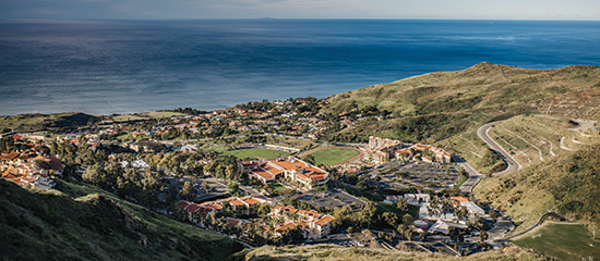 a view of the law school on pepperdine's  campus taken from the mountains overlooking the pacific ocean