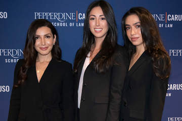 three female students dressed in black suits at a School of Law event