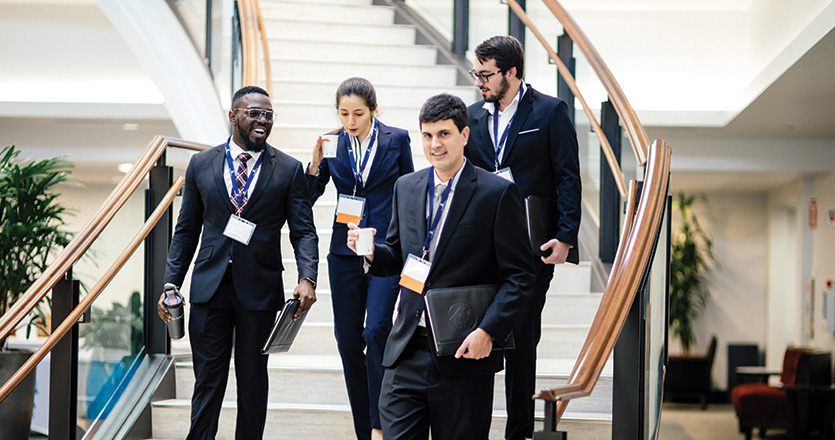 Students at trial lawyers conference walking down stairs inside