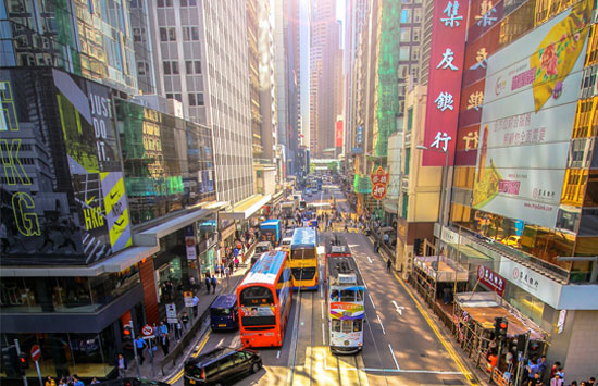 a busy and colorful street in Hong Kong