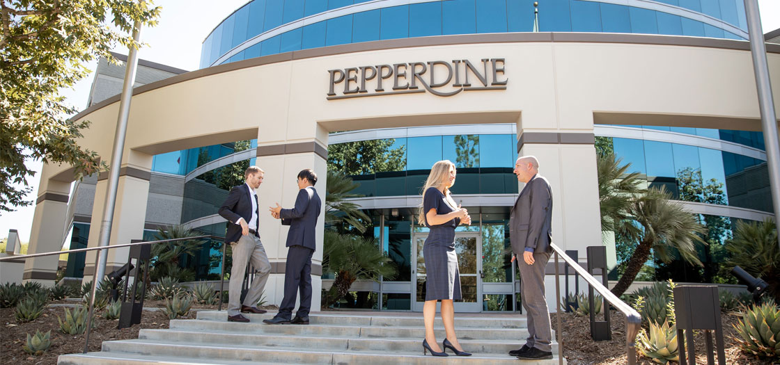 four people dressed in professional clothing stand outside of the Pepperdine University Calabasas office