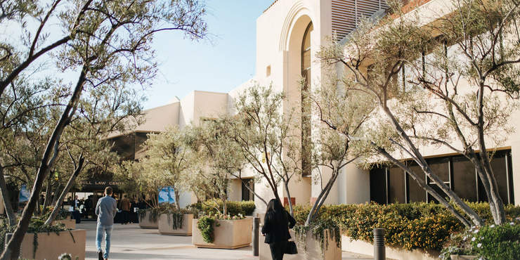 two people walking towards the doors of the Pepperdine School of Law 