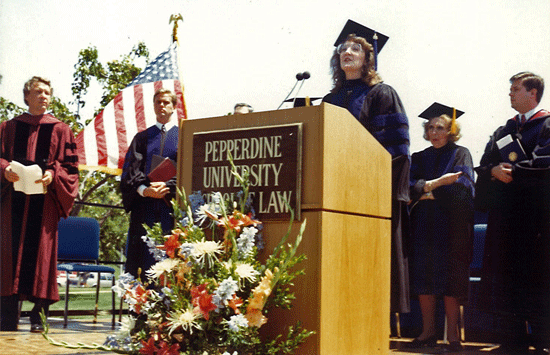 A throwback image of a graduate giving a speech in graduation garb
