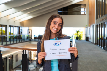 Girl holding Pepperdine Gives card