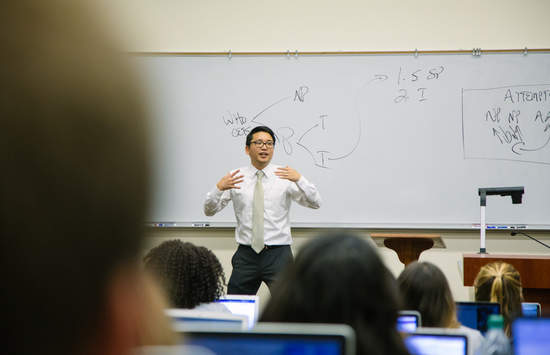 David Han teaching in front of a white board at the School of Law