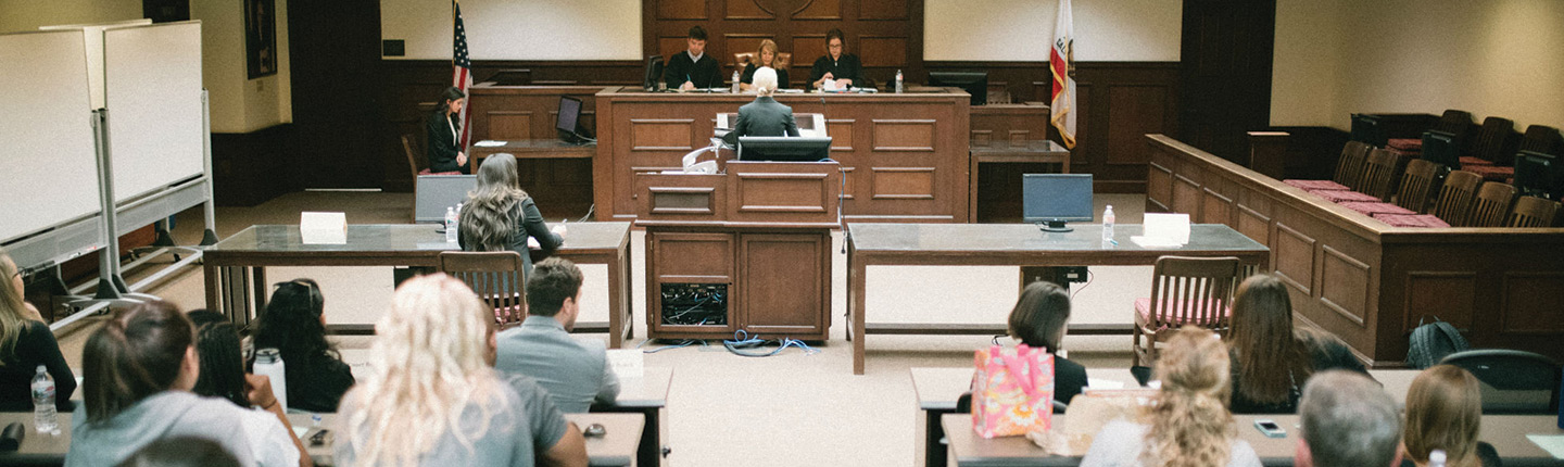 Law students argue in front of judges in the trial courtroom