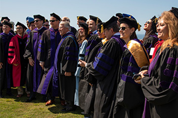 law faculty line up for a photo during commencement