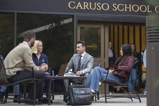 dispute resolution students sitting outside caruso school of law building
