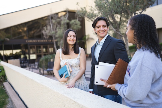pepperdine law students standing outside the caruso school of law building