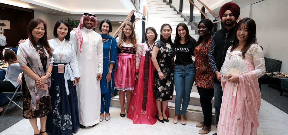 students and staff of various culture and nationality pictured in native garb at an event