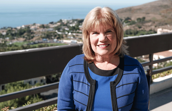 Shelley Saxer sitting on the Caruso School of Law back terrace overlooking the ocean