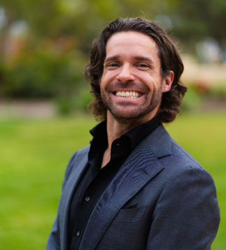 An indoor headshot of Stephen White in front of a window.