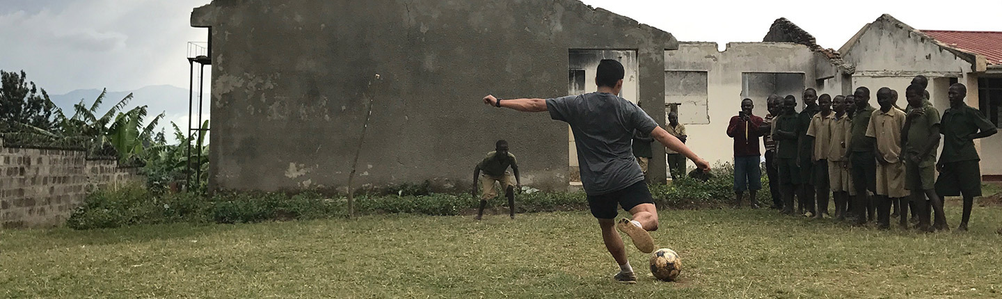 An attorney playing soccer in Ugandan Remand home