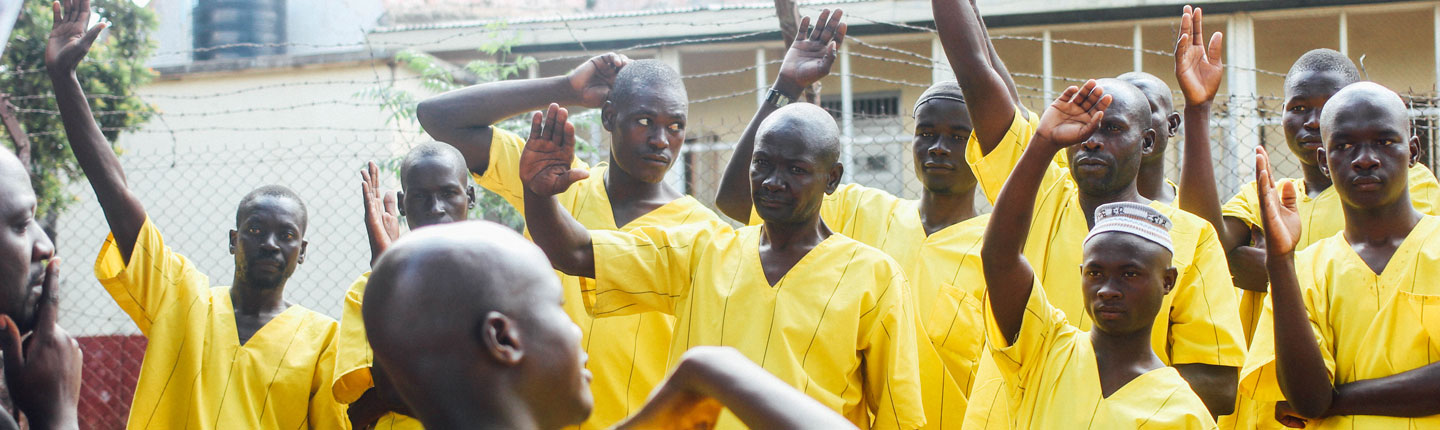Uganda inmates raising hands