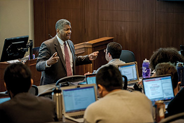 Professor Bernard James lecturing in front of students