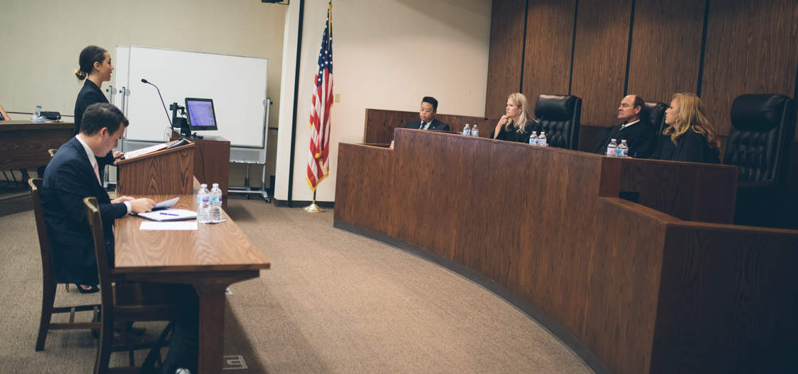Students in the moot court program argue a case before three judges