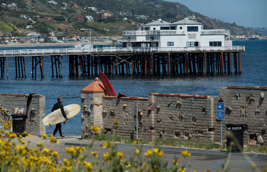 Malibu Pier Surfrider beach parking lot with flowers in the foreground