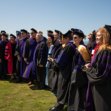 law faculty line up for a photo during commencement