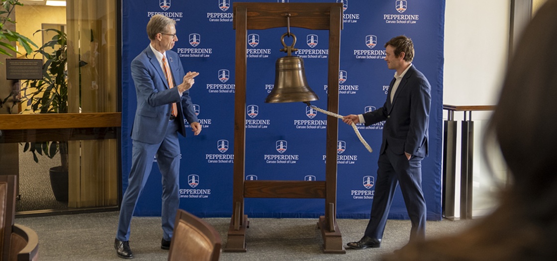 Dean Paul Caron and student bell-ringer
