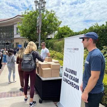 Graduates receiving box lunches