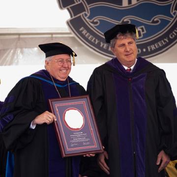 Andrew Benton with Mike Leach at law school commencement 2019