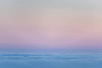 The purple sunset seen above the clouds