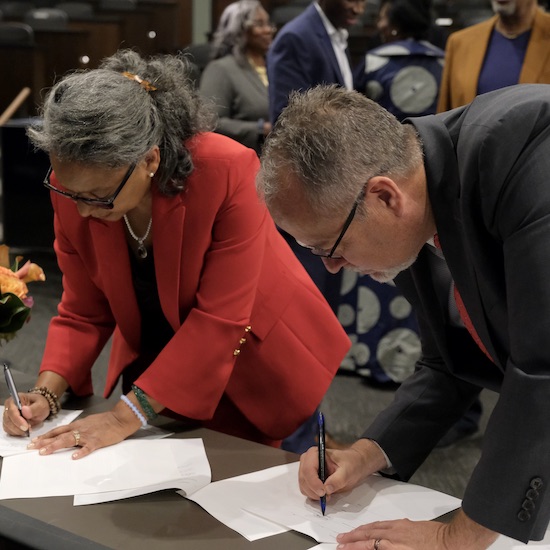 Faye Hall Jackson of Tuskegee University and Jay Brewster of Pepperdine University sign a memorandum of understanding