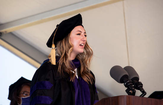 A graduate sings the National Anthem