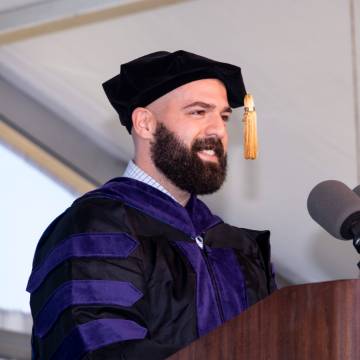 Luke Manzo delivering student address at commencement