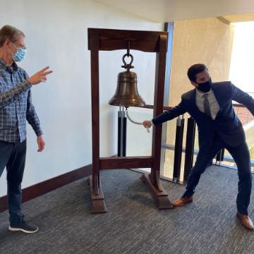 Andrew Schafer rings the bell at Caruso Law