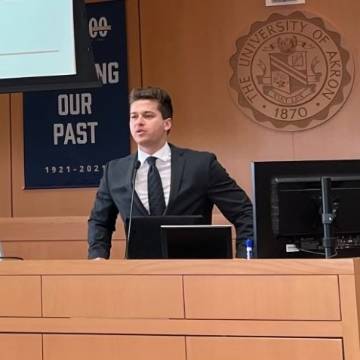 Brandon Posivak speaking at University of Akron symposium