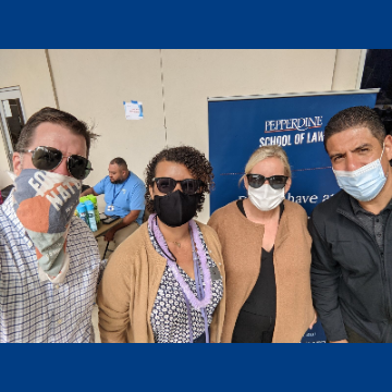 Photo of Caruso Law professors at community day 2021