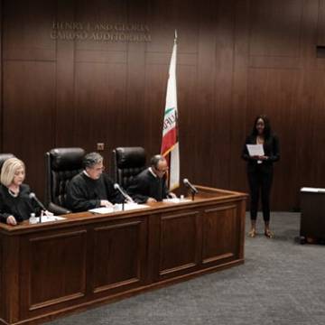 Caruso Law judges sitting at bench