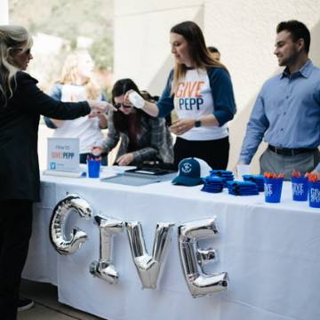Students standing at Give to Pepp donation table