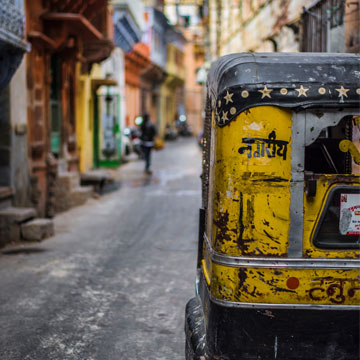 old black and yellow car on a street in India 