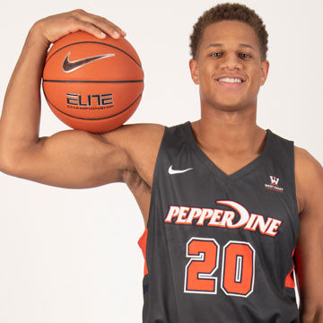 Kameron Edwards in his Pepperdine jersey holding a basketball