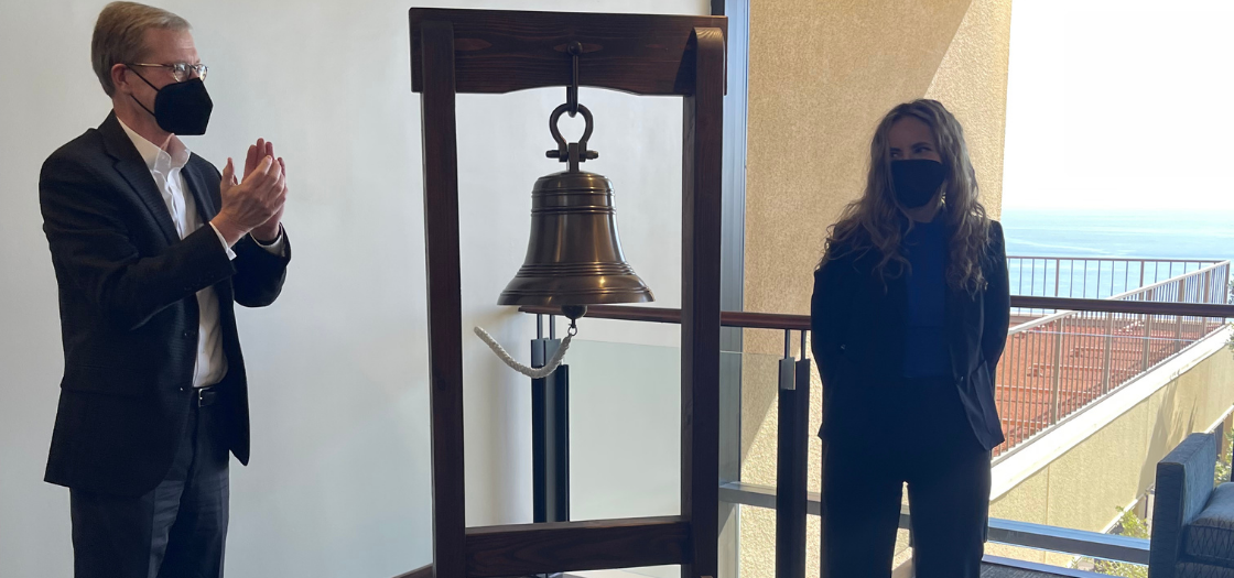 Katrina rings the bell and dean Caron claps