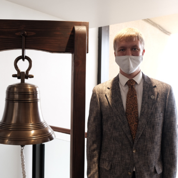 Matthew Dillon next to the jobs bell
