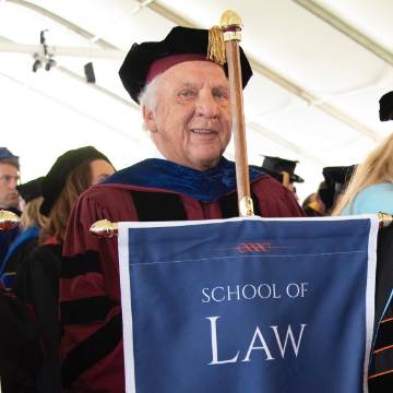 Jim McGoldrick with School of Law banner