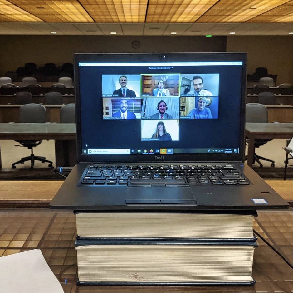 students appear on a laptop screen for a Zoom meeting