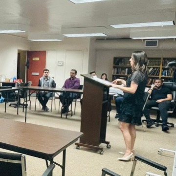 Sarah Nissel speaking at podium