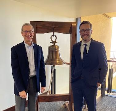 Paul Caron and Tanner Hendershot with jobs bell