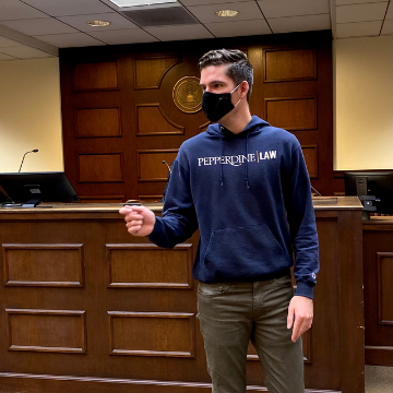 A trial team student argues in the courtroom at Caruso Law