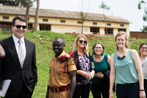 four Pepperdine Caruso Law students with ugandan prison guard