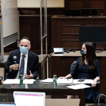 Rabbi Yona Reiss sitting next to Sarah Nissel